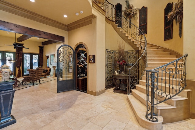 interior space featuring recessed lighting, ceiling fan, a high ceiling, and stairs