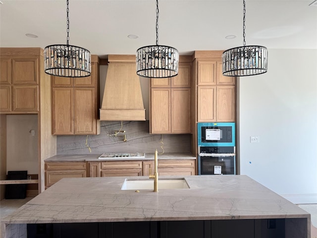 kitchen with stainless steel appliances, a chandelier, and a sink