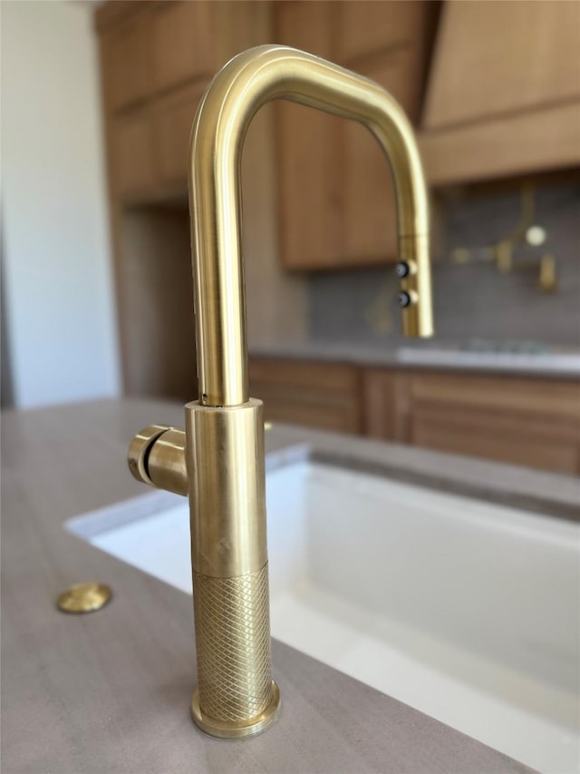 details with brown cabinets and a sink