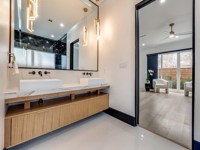 bathroom with double vanity, ceiling fan, visible vents, and a sink