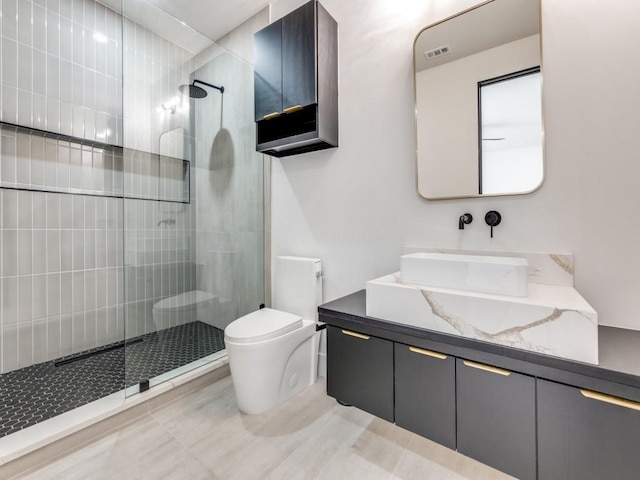 bathroom with vanity, tile patterned flooring, walk in shower, and toilet