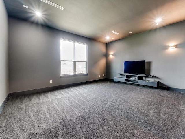 unfurnished living room with recessed lighting, carpet flooring, and baseboards