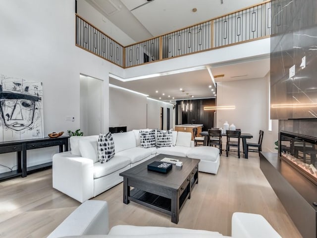 living room featuring a high ceiling and wood finished floors