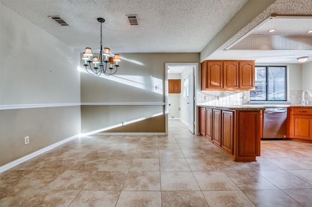 kitchen featuring dishwasher, tasteful backsplash, visible vents, and brown cabinets