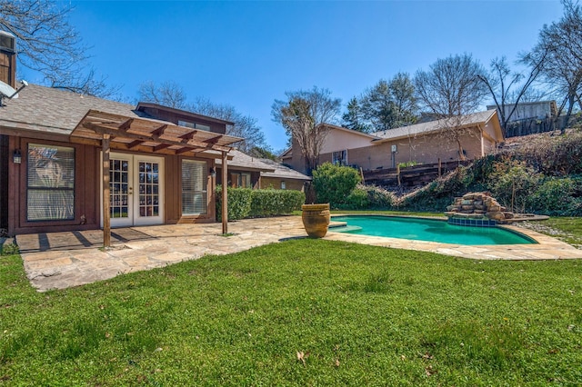 view of pool featuring a fenced in pool, french doors, a patio area, and a lawn