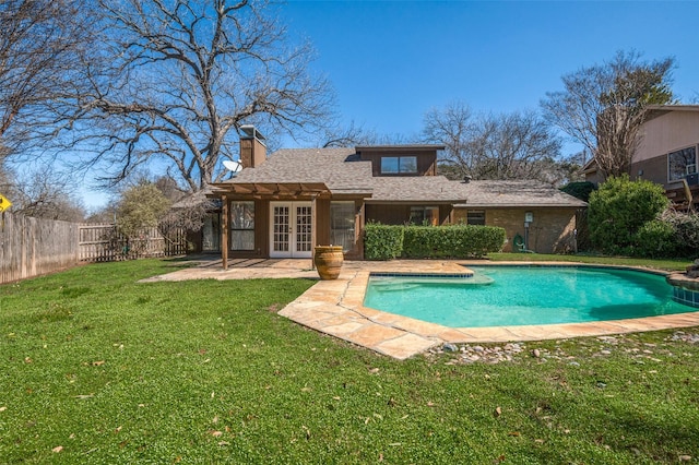 view of swimming pool featuring a fenced in pool, a lawn, a fenced backyard, french doors, and a patio area