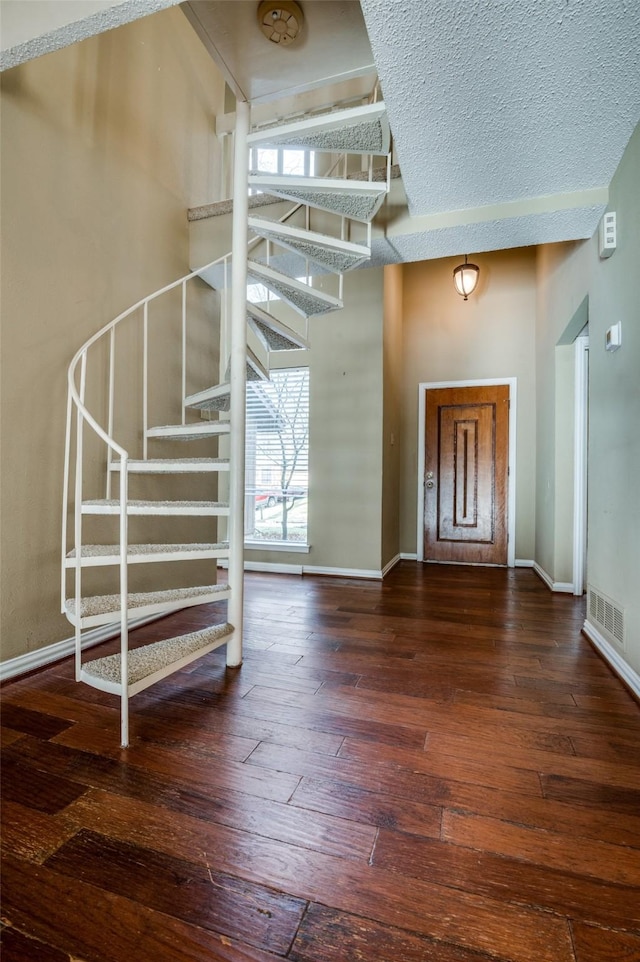 foyer featuring stairs, baseboards, and hardwood / wood-style flooring