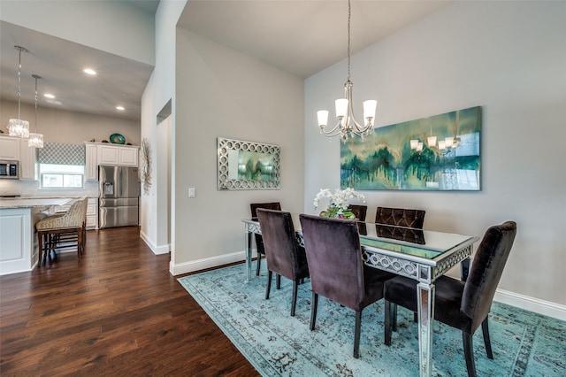 dining space with recessed lighting, dark wood finished floors, baseboards, and an inviting chandelier