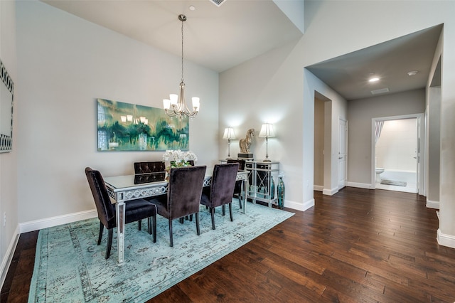 dining space featuring a notable chandelier, hardwood / wood-style floors, visible vents, and baseboards