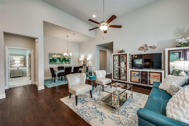 living room with high vaulted ceiling, ceiling fan with notable chandelier, wood finished floors, visible vents, and baseboards