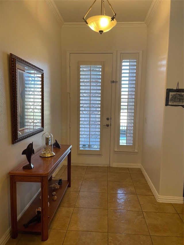 foyer featuring light tile patterned flooring, crown molding, and baseboards