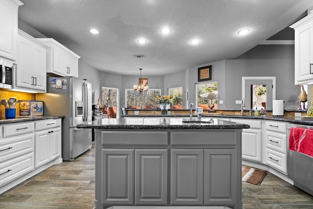 kitchen with stainless steel appliances, recessed lighting, white cabinets, and a sink