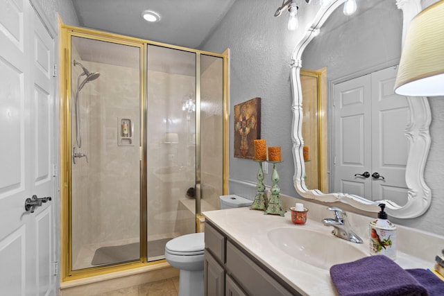 full bath featuring toilet, a shower stall, vanity, and tile patterned floors