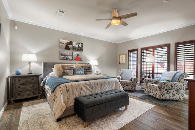 bedroom with ornamental molding, hardwood / wood-style floors, and visible vents