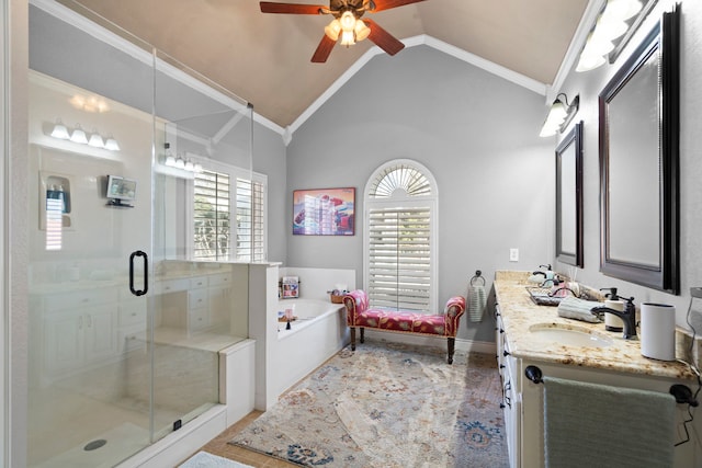 bathroom with lofted ceiling, a garden tub, vanity, ornamental molding, and a stall shower