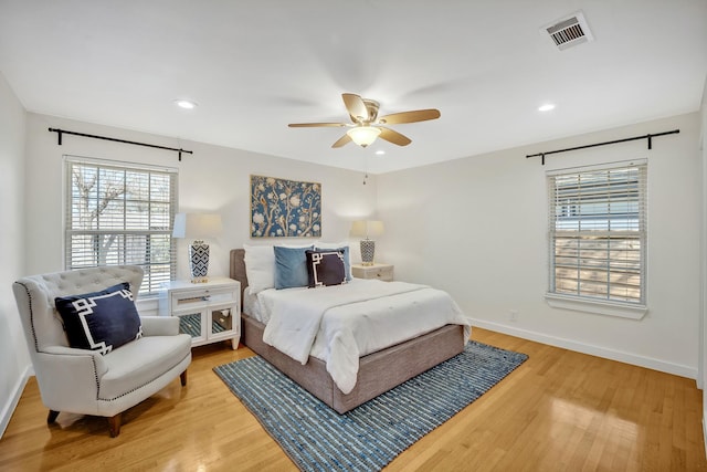 bedroom featuring light wood-style flooring, visible vents, baseboards, and recessed lighting