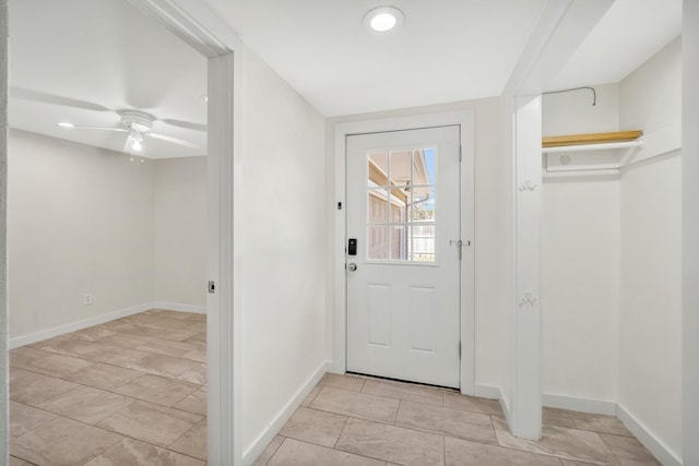 entryway with baseboards and a ceiling fan