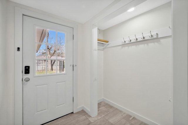 doorway to outside featuring baseboards