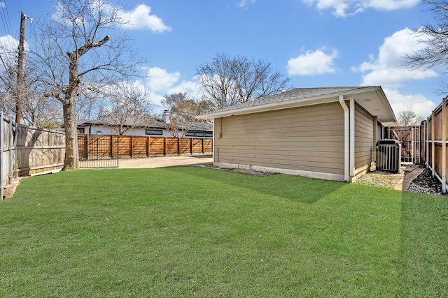 view of yard featuring a fenced backyard, central AC, and a patio