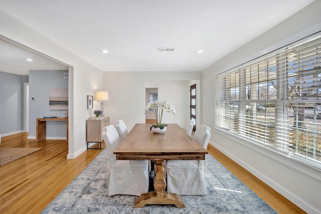 dining space with light wood-style floors, recessed lighting, visible vents, and baseboards