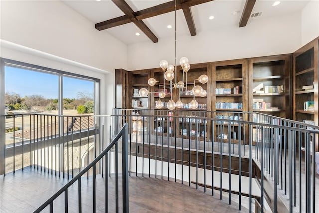 interior space with recessed lighting, a notable chandelier, wood finished floors, visible vents, and beam ceiling