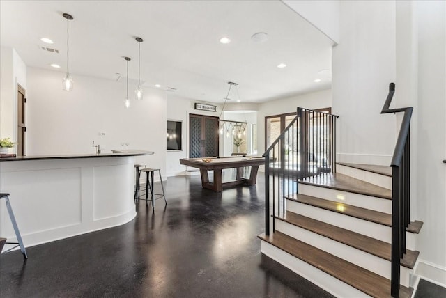 interior space featuring recessed lighting, visible vents, baseboards, stairway, and pendant lighting