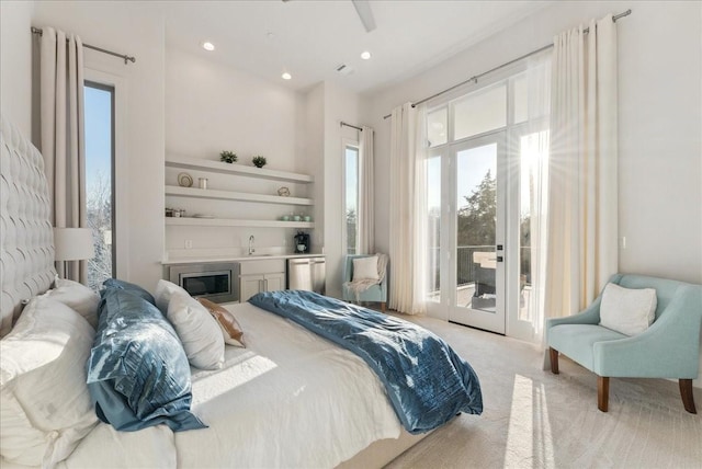 bedroom with recessed lighting, light colored carpet, a sink, access to outside, and french doors