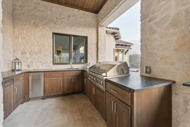 view of patio / terrace featuring a sink, exterior kitchen, and a grill