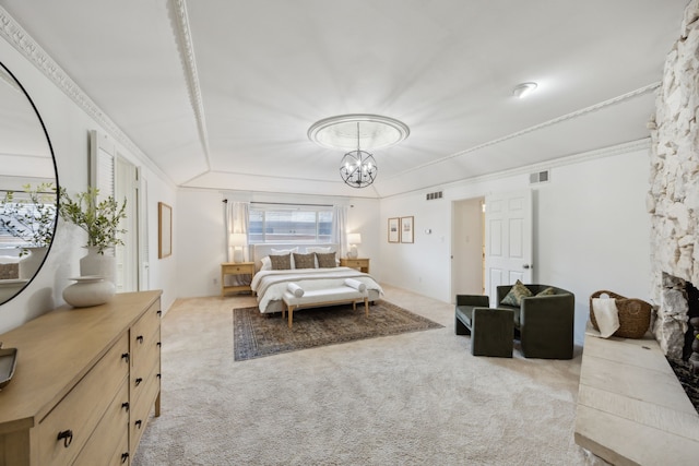 bedroom featuring carpet, visible vents, a notable chandelier, and a stone fireplace