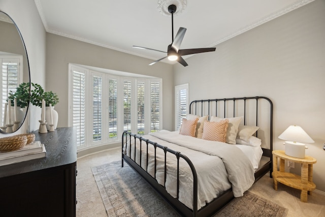 bedroom featuring light carpet, crown molding, baseboards, and ceiling fan