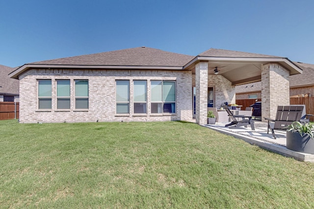 back of property featuring fence, a patio, and brick siding