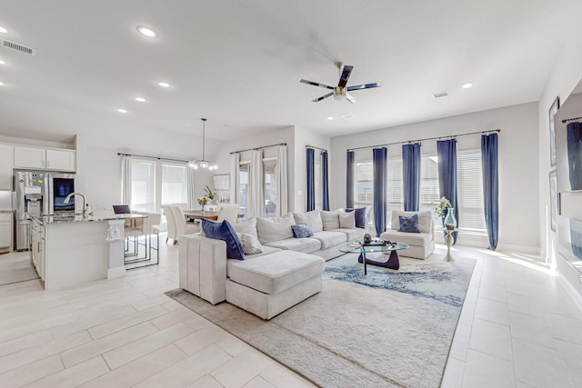 living area featuring recessed lighting, visible vents, and ceiling fan