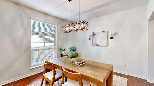 dining area with dark wood finished floors and baseboards