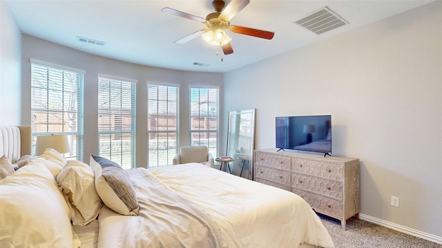 bedroom featuring light carpet, visible vents, and baseboards