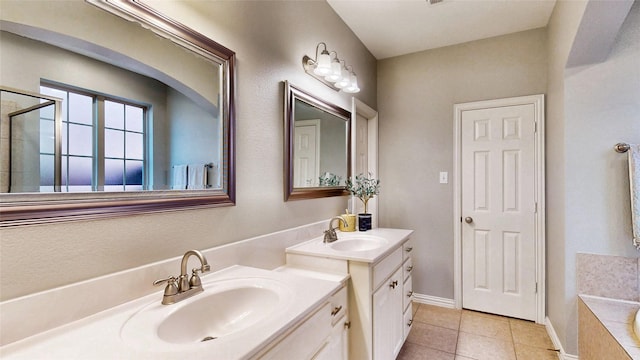 bathroom featuring tile patterned flooring, two vanities, a sink, and a tile shower