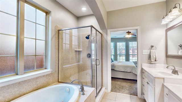 ensuite bathroom with tile patterned flooring, vanity, a shower stall, a bath, and ensuite bath