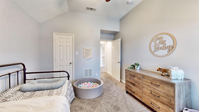 bedroom with light colored carpet, visible vents, and vaulted ceiling