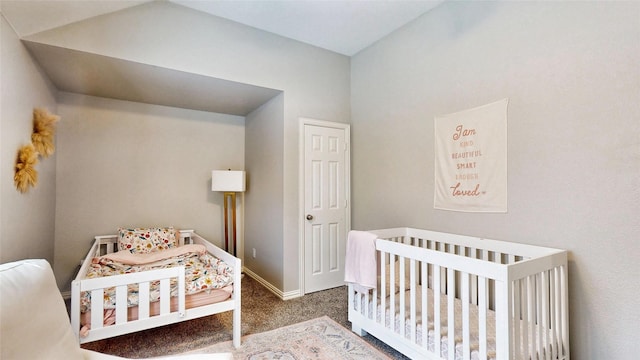 bedroom with a nursery area, carpet flooring, and baseboards