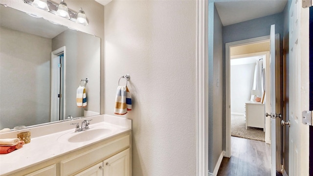 bathroom with wood finished floors and vanity