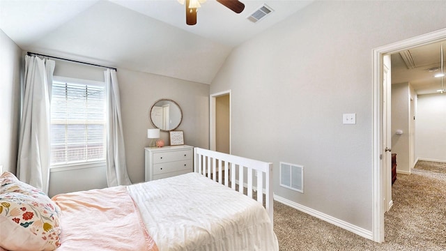 bedroom with attic access, lofted ceiling, visible vents, and carpet floors