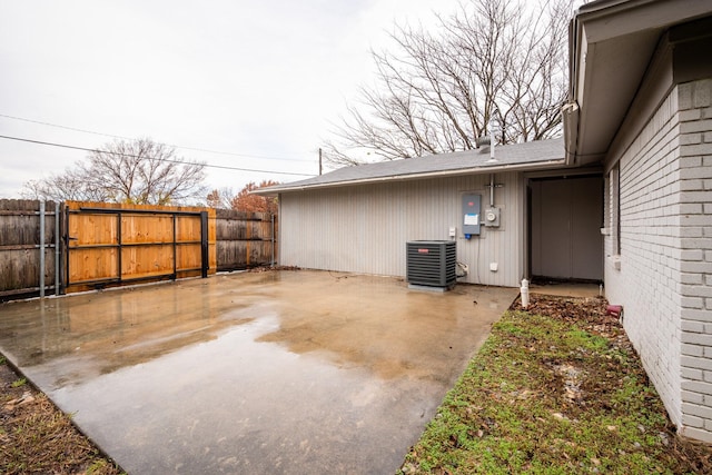 view of yard featuring fence, central AC, and a patio