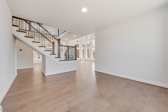 interior space featuring stairs, recessed lighting, wood finished floors, and baseboards