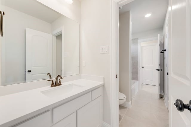 full bathroom featuring a tub to relax in, recessed lighting, toilet, vanity, and tile patterned flooring