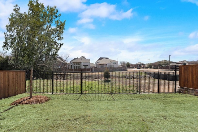 view of yard featuring fence and a residential view