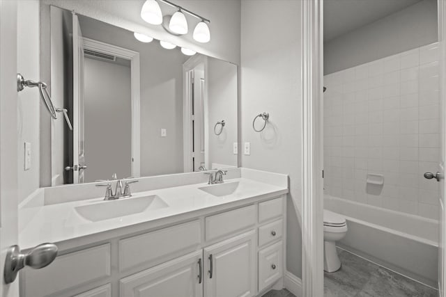 full bath featuring shower / bath combination, a sink, toilet, and double vanity