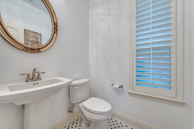 3037 Little Ml, The Colony, TX 75056 - half bathroom with toilet, tile patterned floors, and baseboards