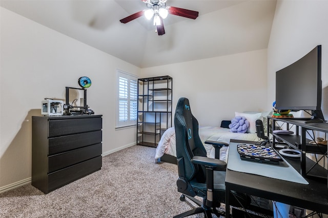 carpeted office featuring baseboards, lofted ceiling, and ceiling fan