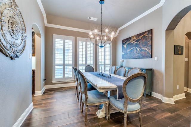 dining room featuring visible vents, crown molding, wood tiled floor, arched walkways, and a notable chandelier