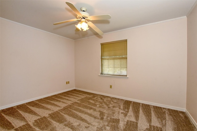 empty room featuring a ceiling fan, carpet, crown molding, and baseboards