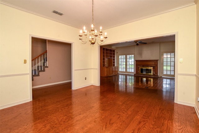 interior space with a fireplace, wood finished floors, visible vents, baseboards, and ornamental molding